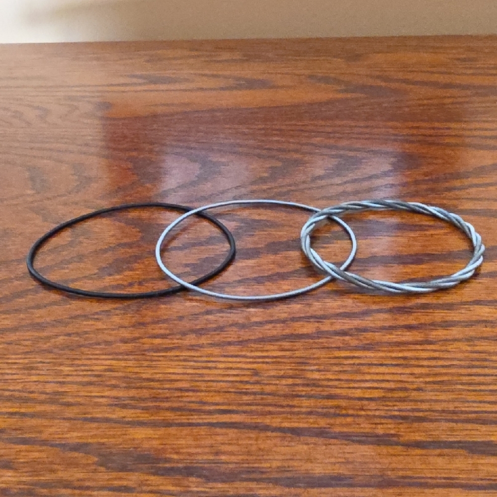 Set Of Three Piano wire bracelets.